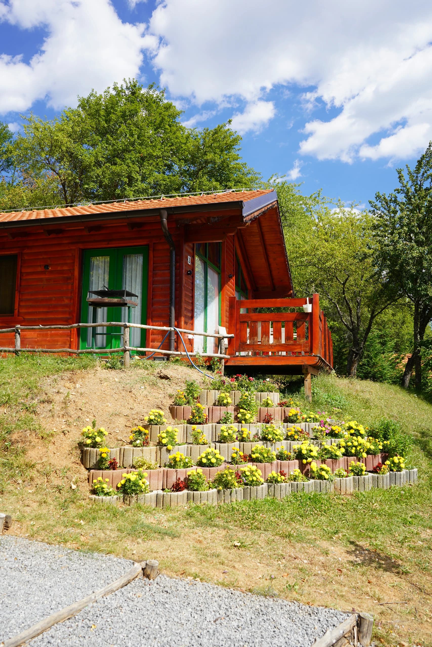 A timber villa wrapped in summer flowers